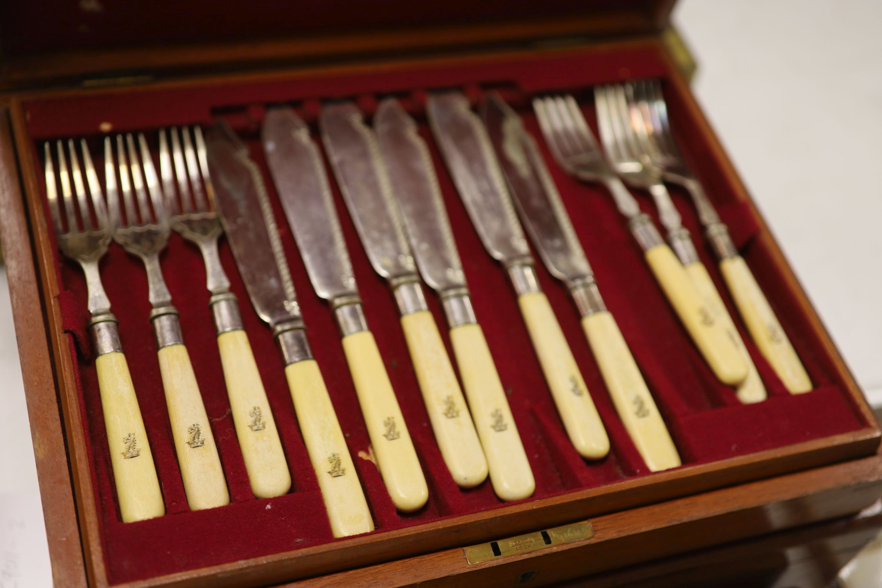 Three boxes of mixed fish eaters and flatware and two boxes of silver teaspoons and silver knives and forks.